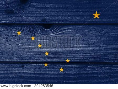 Alaska Flag Painted On Old Wood Plank Background. Brushed Natural Light Knotted Wooden Board Texture