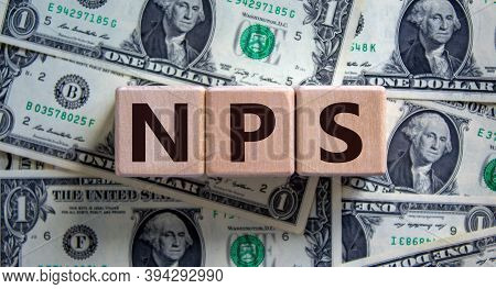 Wood Cubes With Acronym 'nps' - 'net Promoter Score' On A Beautiful Background From Dollar Bills. Bu
