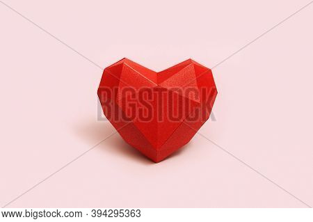 Red Polygonal Paper Heart Shape On Cream Colored Background. Holiday Background With Copy Space For 