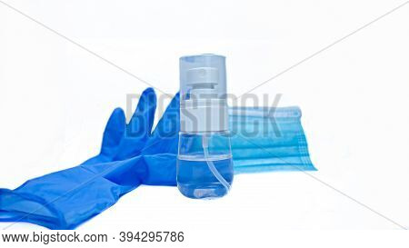 A Close-up Disinfectant Spray, Along With A Blue Glove And Mask, Isolated On A White Background.