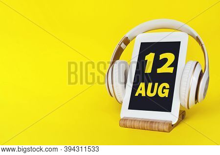 August 12nd. Day 12 Of Month, Calendar Date. Stylish Headphones And Modern Tablet On Yellow Backgrou
