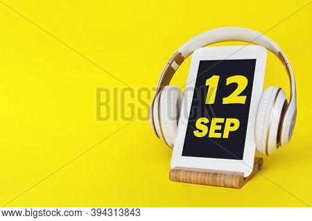 September 12nd. Day 12 Of Month, Calendar Date. Stylish Headphones And Modern Tablet On Yellow Backg