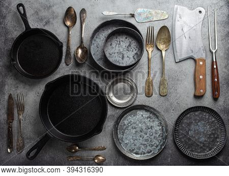 Old Vintage Tableware And Kitchen Utensils On Rustic Stone Background, Top View. Various Metallic Pl