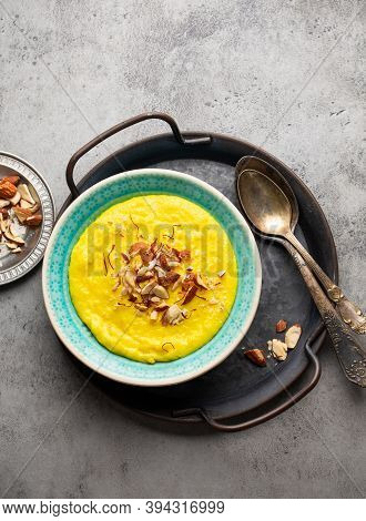 Traditional Indian Dish Kheer, Sweet Rice Milk Pudding With Almonds And Saffron In Blue Ceramic Bowl