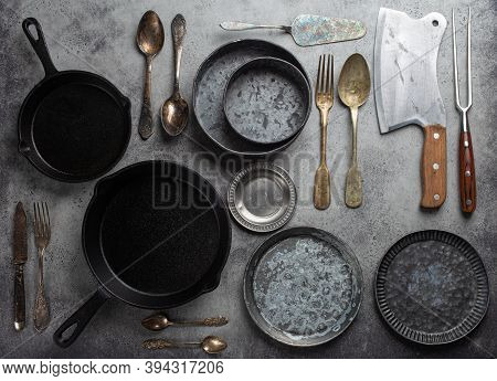 Old Vintage Tableware And Kitchen Utensils On Rustic Stone Background, Top View. Various Metallic Pl