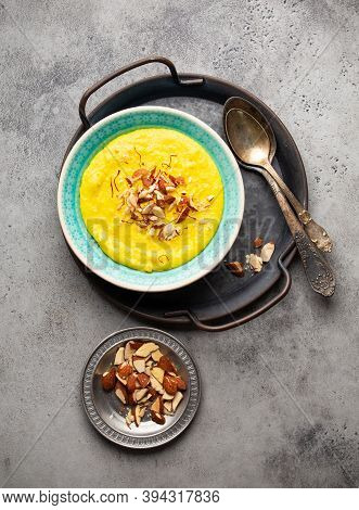 Traditional Indian Dish Kheer, Sweet Rice Milk Pudding With Almonds And Saffron In Blue Ceramic Bowl