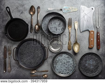 Old Vintage Tableware And Kitchen Utensils On Rustic Stone Background, Top View. Various Metallic Pl