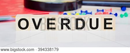 Overdue Invoices Concept. Word Overdue Written On Wooden Cubes