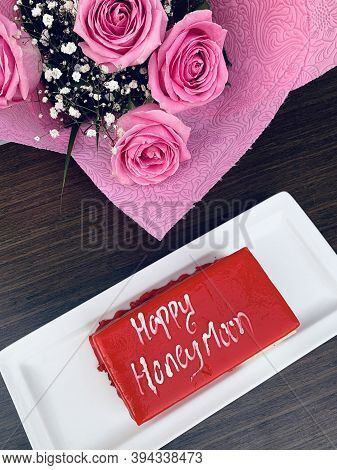 Pink Roses Bouquet And Piece Of Red Velvet Cake With Written Words Happy Honemoon, Hotel Resort Comp