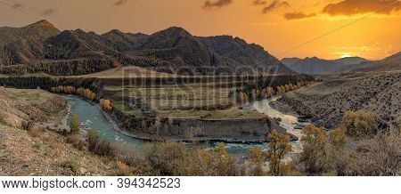 Altai Mountains. Beautiful Highland Autumn Panoramic Landscape At Sunset. Golden Hour. Rocky Foregro