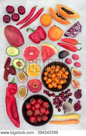Fruit & vegetables high lycopene & anthocyanins to reduce cholesterol for a healthy heart with foods also high in antioxidants, omega 3, vitamins, minerals & dietary fibre. Flat lay on mottled grey.