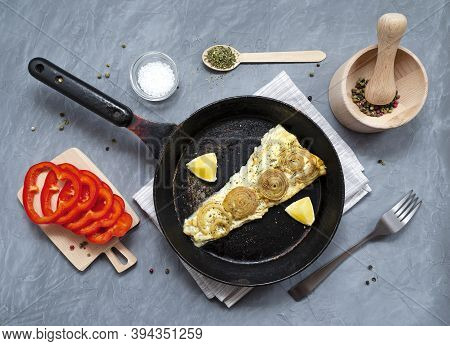 Fried Baked Mackerel Trachurus With Onions And Dried Herbs In An Old Frying Pan With A Towel And For