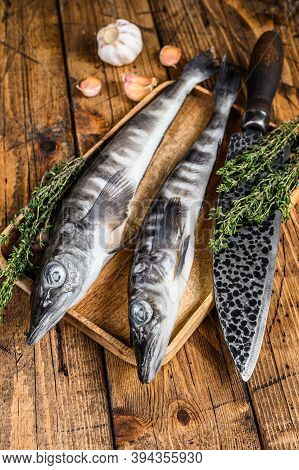 Raw Mackerel Icefish In A Wooden Tray. Wooden Background. Top View
