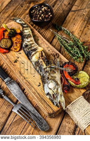 Grilled Whole Icefish With Vegetables. Wooden Background. Top View