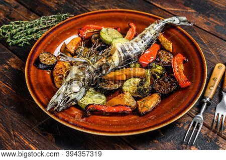 Baked Whole Icefish With Grilled Vegetables. Dark Wooden Background. Top View