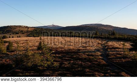 Meadows On A Mountain Ridge With Pole Marked Walking Path And A Transmitter On A Hill In The Backgro