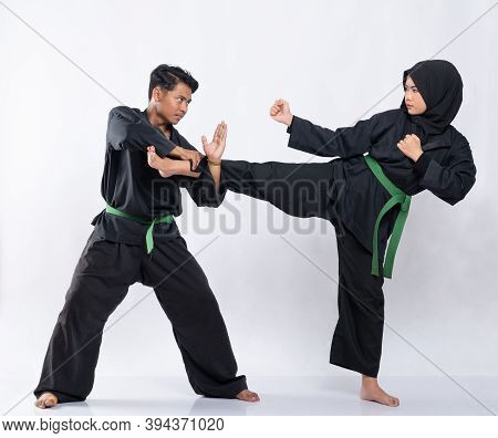 Asian Men And Women Wearing Pencak Silat Uniforms Fight