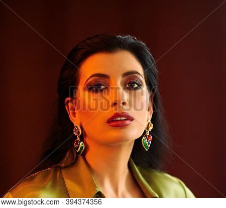 Beautiful Woman Wearing Green Shirt And Earrings