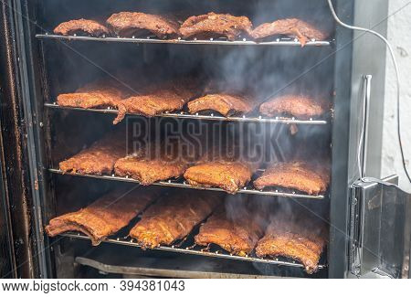 Smoke Rising Around A Slow Cooked Beef Brisket On A Smoker Barbecue Grilling Concept