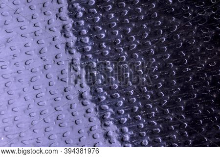 Cloe Up Lit Shiny Surface Of Black Sticky Tape With Divots