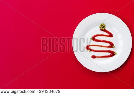 Ketchup In A White Plate Looks Like A Christmas Tree. Green Peas Serve As A Decoration. The Plate St