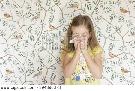 A Nice Little Girl Sneezes Into A Handkerchief Because She Has A Seasonal Allergy To Pollen And Flow