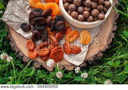 Different Chicken And Macadamia Nut On A Wooden Background On The Grass. Photo For The Catalog. Asso