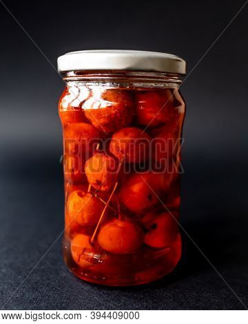 Glass Jar Of Paradise Apples On A Dark Background