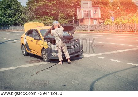 Taxi Driver Saves The Car From Overheating On A Hot Summer Day. Problems With Engine In Car Standing
