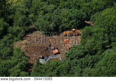 Construction Equipment Works In The Forest Among The Trees - July 10, 2020, Moscow, Russia