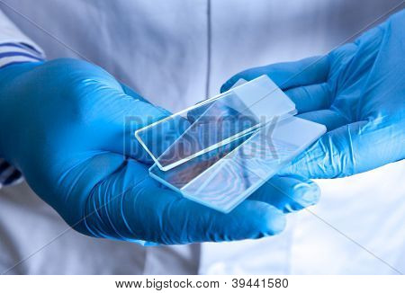 Scientist holding frosted glass microscope slides