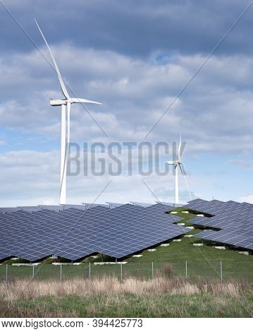 Wind Turbines And Solar Panels Form Alternative Enery Plant In The Netherlands Under Blue Sky With C
