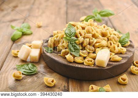 Tortellini Mignon, Basil With Parmesan. Specialties Of The Cuisine From Bologna And Emilia Romagna: 