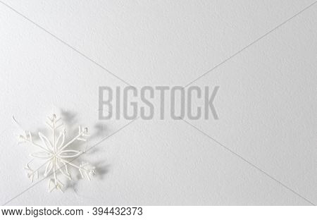 White Background With A Plastic Snowflake In The Corner, A Shadow Falls From It. Texture Of Watercol