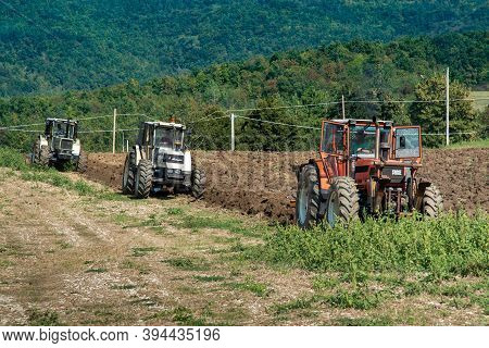 September 2020, Calestano Province Of Parma, Italy. Three Tractors Plowing A Field. Same Galaxy 170.