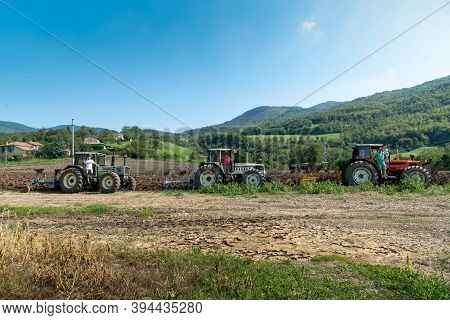 September 2020, Calestano Province Of Parma, Italy. Three Tractors Plowing A Field. Same Galaxy 170.