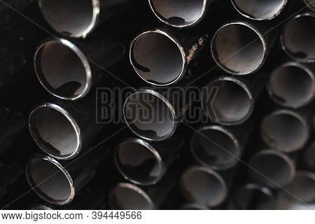 Black Metal Pipes For Gasification Or Water Supply. Industrial Background Close Up