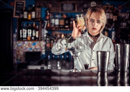 Experienced Woman Mixologist Makes A Cocktail In The Night Club