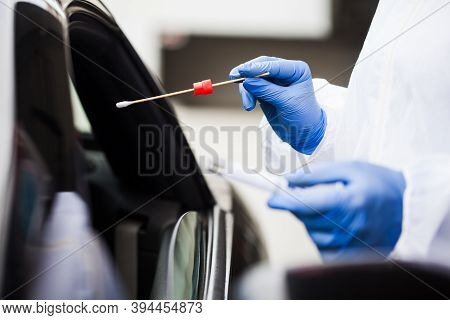 Medical Worker Wearing Personal Ppe Surgical Gloves And Protective Clothing,holding Nasal Swab,perfo