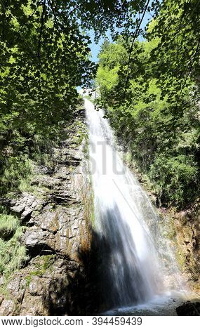 High Waterfall With Lots Of Sparkling Water In The Middle Of The Forest In An Unspoiled Natural Land