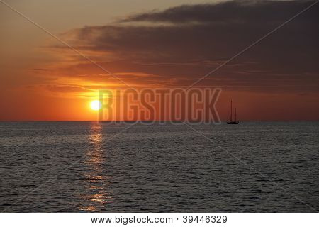 Watercraft In Sea At Sunset
