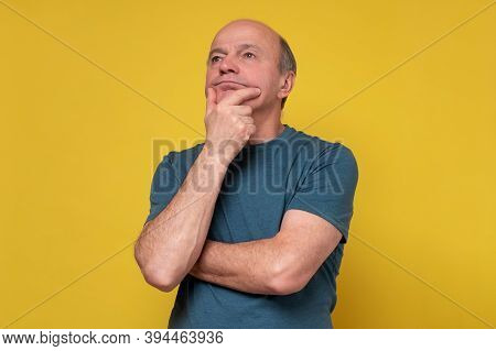 Senior Man Scratching His Chin Making A Hard Decision