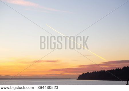 Airplane Cloud Trail In The Sky During A Colorful Sunset In Whiterock, Vancouver, British Columbia, 