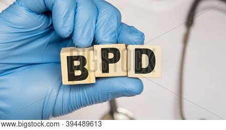 Bpd Borderline Personality Disorder - Word From Wooden Blocks With Letters Holding By A Doctors Hand