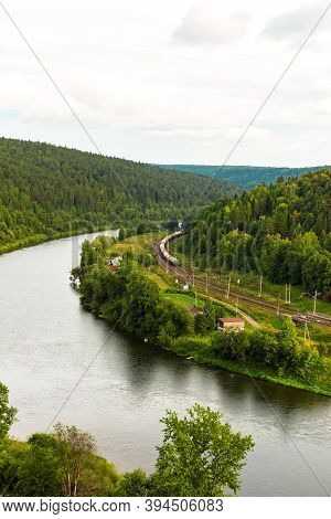 Kungur, Perm Region, Russia - August, 8 2020: Long Multicolored Freight Train Goes Along Chusovaya R