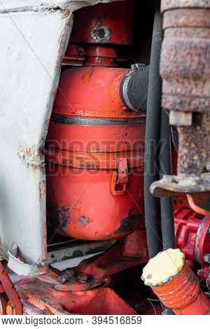 Closeup Of Coolant Reservoir In Old Vibrant Red Rusty Russian Tractor Engine On Sunny Autumn Day Sha