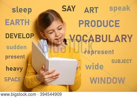 Cute Little Girl Reading Vocabulary Surrounded By Different Words In English On Yellow Background