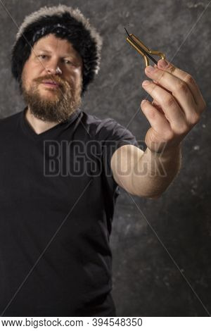 Matured Man In Fur Hat Playing Jews Harp