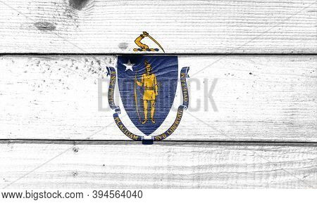 Massachusetts Flag Painted On Old Wood Plank Background. Brushed Natural Light Knotted Wooden Board 