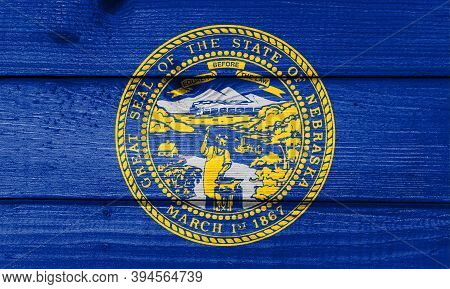 Nebraska Flag Painted On Old Wood Plank Background. Brushed Natural Light Knotted Wooden Board Textu